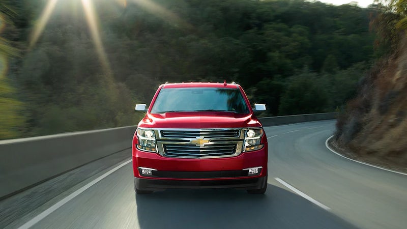 Red Chevrolet Tahoe in motion on the road