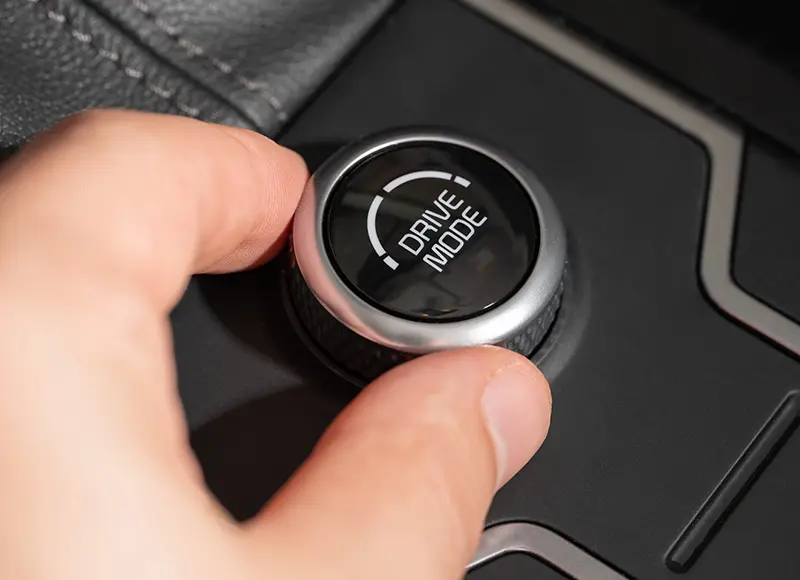 Hand adjusting vehicle drive mode selector knob